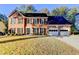 Beautiful two-story brick home with a well-manicured lawn and a two-car garage at 3034 Brookgreen Trl, Lawrenceville, GA 30043