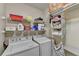 Well-organized laundry room equipped with washer, dryer, shelving, and ample storage space at 3034 Brookgreen Trl, Lawrenceville, GA 30043