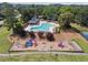 Aerial view of a community pool, playground and green space with trees at 11940 Wexford Club Dr, Roswell, GA 30075