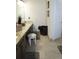 Bathroom features stylish tile flooring, dark cabinets, and a granite countertop at 11940 Wexford Club Dr, Roswell, GA 30075