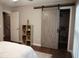 Bedroom featuring a sliding barn door closet, providing a rustic touch and space-saving storage solution at 11940 Wexford Club Dr, Roswell, GA 30075