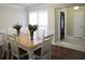 Traditional dining room with hardwood floors, white wainscoting, and decorative centerpieces at 11940 Wexford Club Dr, Roswell, GA 30075
