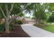 A long driveway leads to the brick home, framed by mature trees, green lawn, and manicured landscaping at 11940 Wexford Club Dr, Roswell, GA 30075