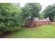 Brick home with lush landscaping in a verdant lawn and mature trees surrounding at 11940 Wexford Club Dr, Roswell, GA 30075