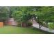 Brick home with two-car garage, lush landscaping, and a well-maintained lawn, offering great curb appeal at 11940 Wexford Club Dr, Roswell, GA 30075