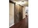 Hallway featuring sliding barn doors, adding a rustic touch and maximizing space in the home at 11940 Wexford Club Dr, Roswell, GA 30075