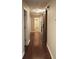 Hallway boasts wood-look flooring, sliding barn door, and seamless transition to adjoining rooms at 11940 Wexford Club Dr, Roswell, GA 30075