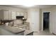 Bright kitchen with stainless steel appliances, neutral cabinets, and tile backsplash at 11940 Wexford Club Dr, Roswell, GA 30075
