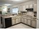 Kitchen with light colored countertops, tiled backsplash and dark appliances at 11940 Wexford Club Dr, Roswell, GA 30075