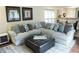 Spacious living room with large sofa, ottoman and decor at 11940 Wexford Club Dr, Roswell, GA 30075