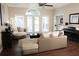 Cozy living room with hardwood floors, a vaulted ceiling, and lots of natural light from large windows at 11940 Wexford Club Dr, Roswell, GA 30075