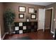 Cozy home office featuring hardwood floors, display shelving, and wall decor, providing an inviting workspace at 11940 Wexford Club Dr, Roswell, GA 30075