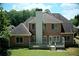 Spacious backyard with a brick two-story house and a wooden deck at 1255 Home Place Dr, Lawrenceville, GA 30043