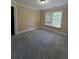 Bedroom with carpet floors and a window letting in natural light at 1255 Home Place Dr, Lawrenceville, GA 30043