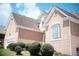 Brick facade home showcasing neutral trim, manicured shrubbery, and asphalt roof at 1255 Home Place Dr, Lawrenceville, GA 30043