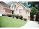 Brick home with brick facade, manicured shrubbery, driveway, and well-maintained lawn at 1255 Home Place Dr, Lawrenceville, GA 30043