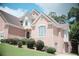 Two-story brick home showcasing manicured shrubbery, brick facade, and neutral trim details at 1255 Home Place Dr, Lawrenceville, GA 30043