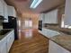 The kitchen features granite counters, white cabinets, and stainless appliances at 1255 Home Place Dr, Lawrenceville, GA 30043