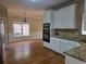 Bright kitchen features granite counters, white cabinets, and hardwood floors at 1255 Home Place Dr, Lawrenceville, GA 30043