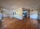 Open-concept living area with hardwood floors that flows into an adjacent dining and kitchen area at 1255 Home Place Dr, Lawrenceville, GA 30043