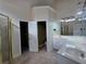 Well-lit bathroom with double sinks, walk-in shower, and an open doorway at 1255 Home Place Dr, Lawrenceville, GA 30043