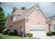 Brick home's side view shows the brick facade, two-car garage, and manicured shrubbery at 1255 Home Place Dr, Lawrenceville, GA 30043