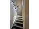 Staircase with white risers and black treads leading upstairs at 1255 Home Place Dr, Lawrenceville, GA 30043