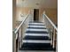 Staircase with white risers and black treads, with a hanging light fixture above at 1255 Home Place Dr, Lawrenceville, GA 30043
