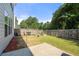 Fenced backyard with a patio, garden, and lush lawn at 1871 Stoney Chase Dr, Lawrenceville, GA 30044
