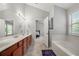 Bright bathroom with double sinks, large mirror, and separate tub with lots of storage at 1871 Stoney Chase Dr, Lawrenceville, GA 30044