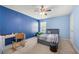 Blue bedroom features a ceiling fan, carpet, and a combination of natural and artificial light at 1871 Stoney Chase Dr, Lawrenceville, GA 30044