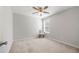 Minimalist bedroom with neutral tones, a large window and carpeted floor at 1871 Stoney Chase Dr, Lawrenceville, GA 30044