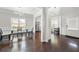 Elegant dining room featuring a modern light fixture, hardwood floors, and ample natural light at 1871 Stoney Chase Dr, Lawrenceville, GA 30044