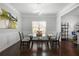 Elegant dining room with modern lighting and a glass-top table for stylish dining at 1871 Stoney Chase Dr, Lawrenceville, GA 30044