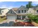 Charming two-story home with a manicured lawn, attached garage, and inviting front porch at 1871 Stoney Chase Dr, Lawrenceville, GA 30044