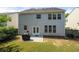 View of home's exterior and well-kept lawn from backyard with patio and grill at 1871 Stoney Chase Dr, Lawrenceville, GA 30044