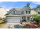 Charming two-story home with a manicured lawn, attached garage, and inviting front porch at 1871 Stoney Chase Dr, Lawrenceville, GA 30044