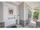 Welcoming front porch with stone accents and seasonal decor, white trim, and wainscoting at 1871 Stoney Chase Dr, Lawrenceville, GA 30044