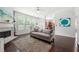 Bright living room flows into kitchen, showcasing fireplace, hardwood floors, and natural light at 1871 Stoney Chase Dr, Lawrenceville, GA 30044