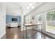 Open-concept view from kitchen to the living room with fireplace, TV, and lots of light at 1871 Stoney Chase Dr, Lawrenceville, GA 30044