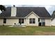 A cozy backyard with patio, table and chairs, and well-maintained lawn at 3066 Gem Creek Rd, Buford, GA 30519