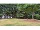 Picturesque backyard featuring a tree, green grass, and a wooden fence for privacy, creating a serene outdoor space at 3066 Gem Creek Rd, Buford, GA 30519