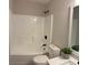 Bright bathroom features a shower and tub combination with black hardware and a modern toilet at 3066 Gem Creek Rd, Buford, GA 30519