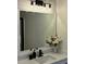 Elegant bathroom with a white-framed mirror, quartz countertop, and stylish black fixtures at 3066 Gem Creek Rd, Buford, GA 30519