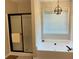 Bathroom featuring a large bathtub, separate shower, and a window overlooking the outdoors at 3066 Gem Creek Rd, Buford, GA 30519