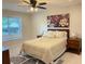 Comfortable bedroom features a plush bed, neutral decor, and a large window with natural light at 3066 Gem Creek Rd, Buford, GA 30519