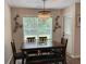 Cozy dining area features a dark wood table, a modern chandelier and artistic wall décor at 3066 Gem Creek Rd, Buford, GA 30519