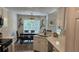 Open-concept kitchen with bright countertops and stainless steel appliances, with view to dining area at 3066 Gem Creek Rd, Buford, GA 30519