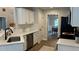 Updated kitchen features white cabinets, stainless appliances, and is adjacent to the dining area at 3066 Gem Creek Rd, Buford, GA 30519