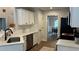 Modern kitchen with white cabinets, stainless steel appliances, and wood flooring at 3066 Gem Creek Rd, Buford, GA 30519
